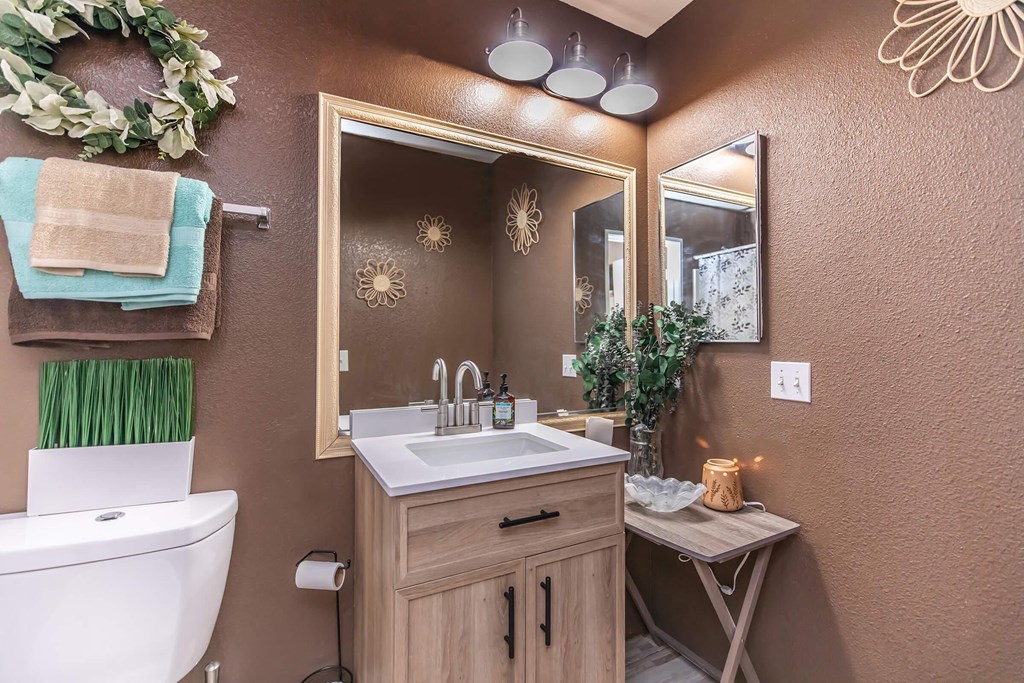 a bathroom with a toilet sink and a mirror
