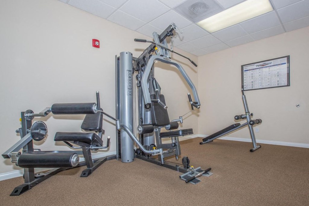 A gym with a variety of equipment including a leg press machine.