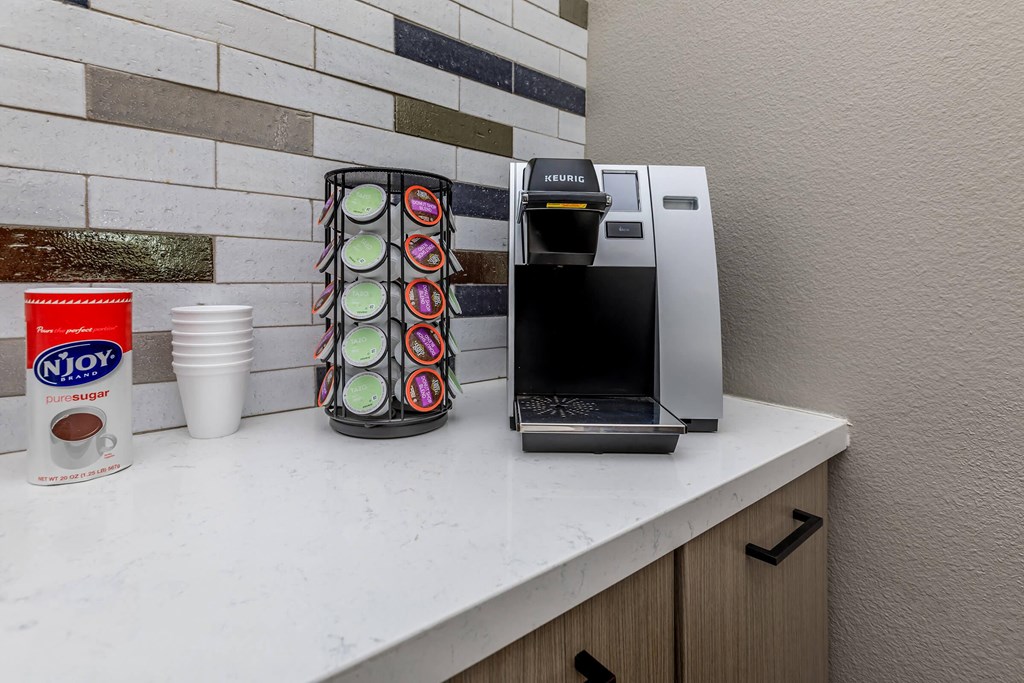 a kitchen with a coffee maker and a microwave on a counter