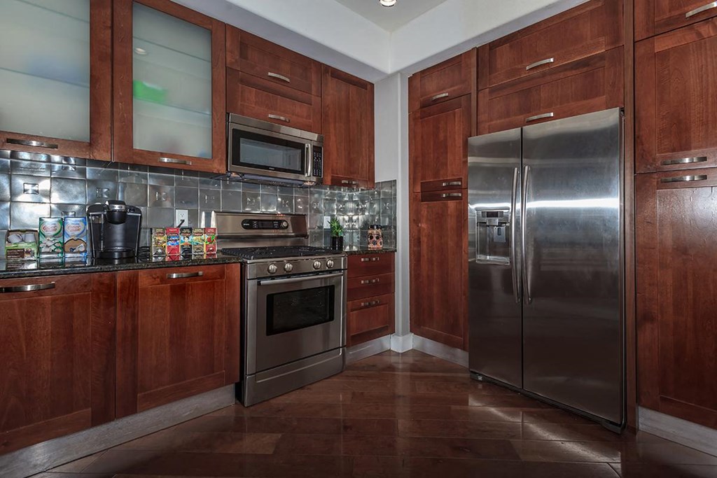a kitchen with stainless steel appliances and wooden cabinets