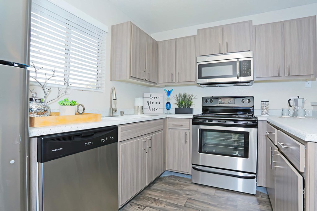 a kitchen with stainless steel appliances and wooden cabinets