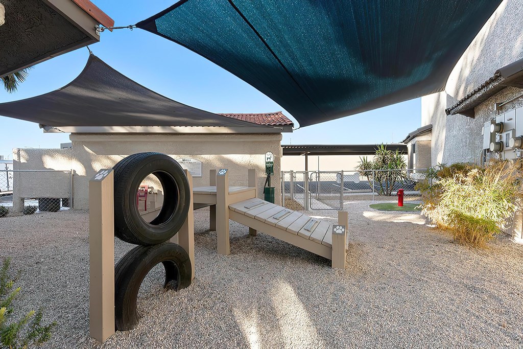 a bench with a tire and awning in a courtyard