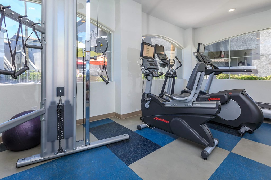 a gym with exercise equipment and a window
