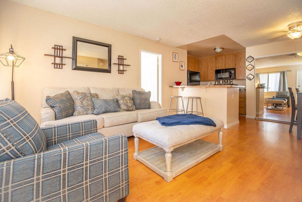 a living room and kitchen with a couch and a table