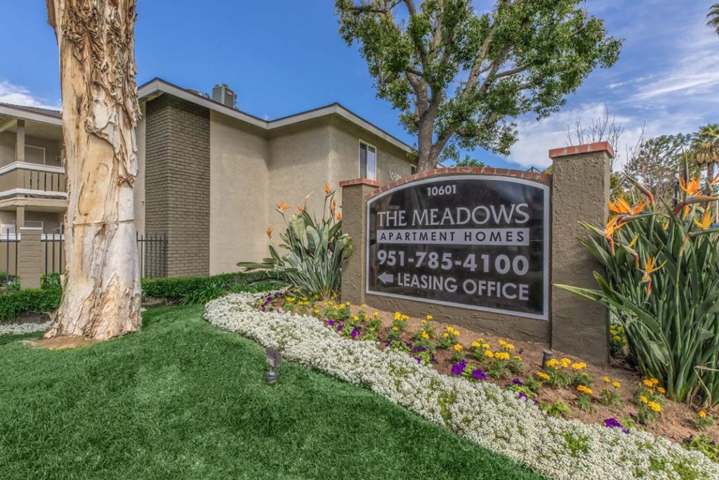 the meadows apartments leasing office sign