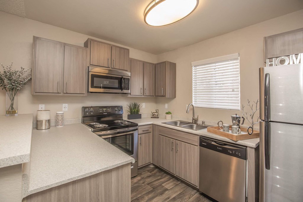 a kitchen with stainless steel appliances and white counter tops