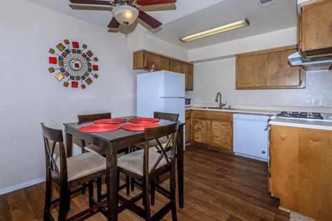 a kitchen with a table and chairs and a refrigerator