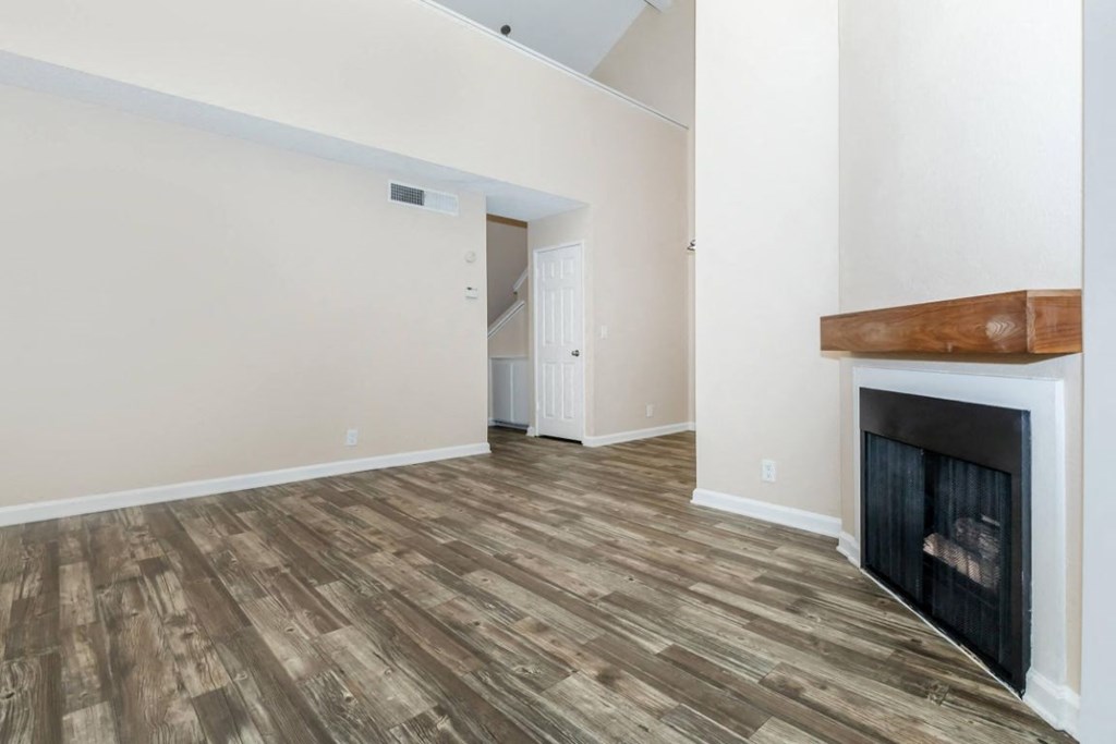 a living room with a fireplace and a white wall