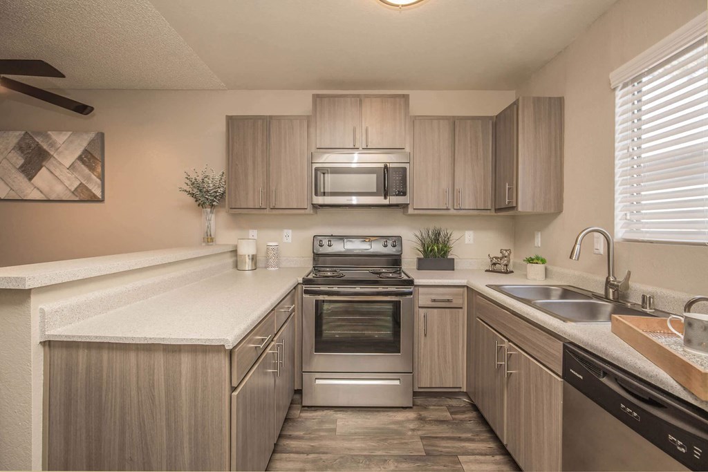 a kitchen with stainless steel appliances and wooden cabinets