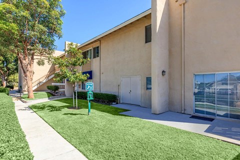 A building with a green sign in front of it.