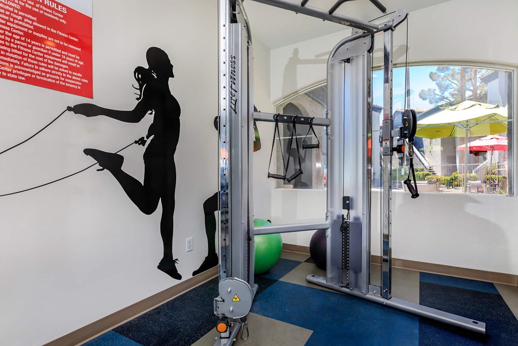 a workout room with a silhouette of a woman on the wall