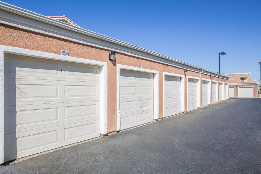 A row of white garage doors are closed.