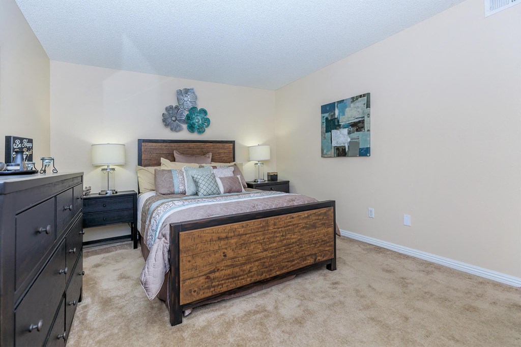 a bedroom with a bed and a dresser