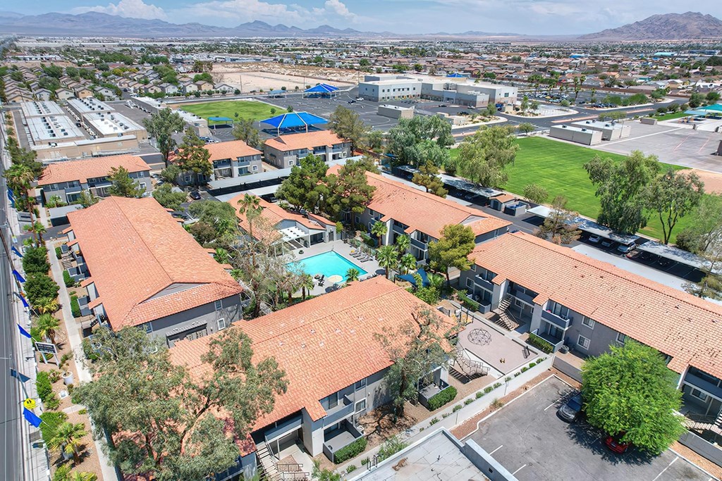an aerial view of a neighborhood with houses and a swimming pool