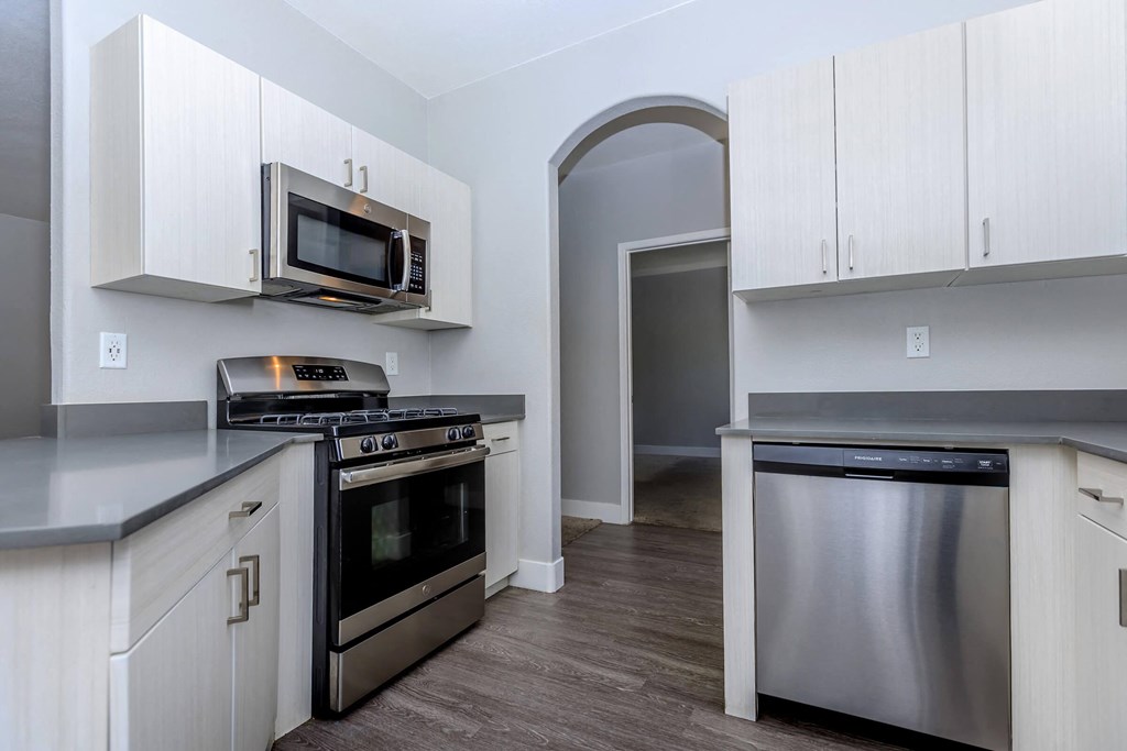 a kitchen with stainless steel appliances and white cabinets