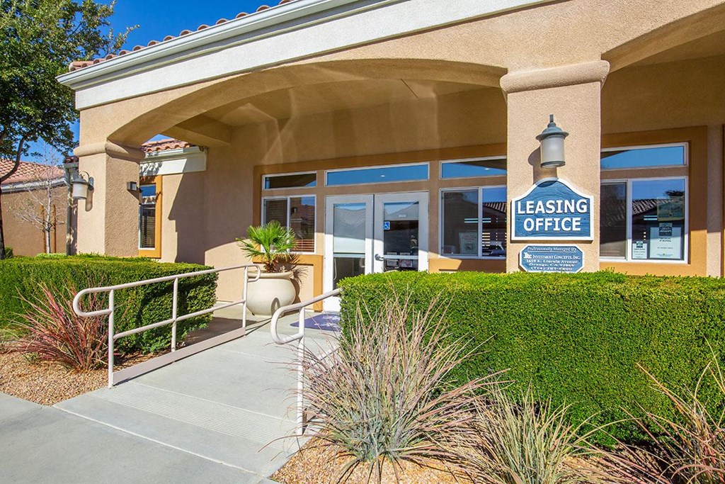 a building with a leasing office sign in front of it