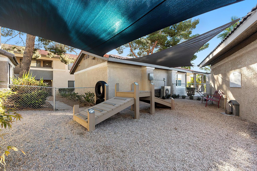 a backyard with a picnic table and a bench