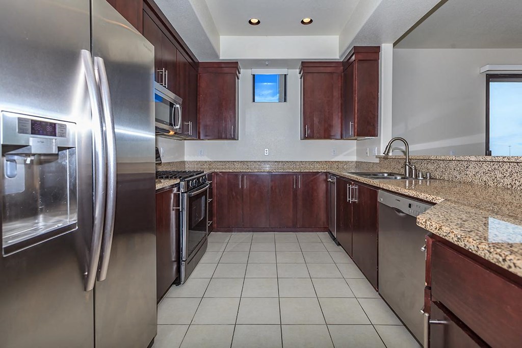 a kitchen with stainless steel appliances and granite counter tops