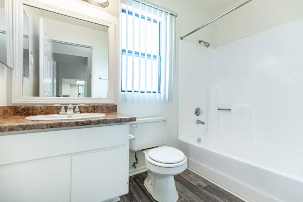a bathroom with a sink toilet and a bath tub