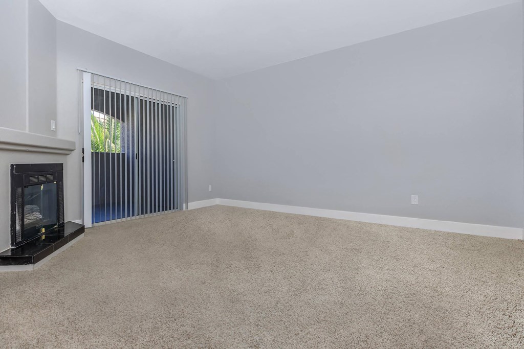a living room with a fireplace and a window