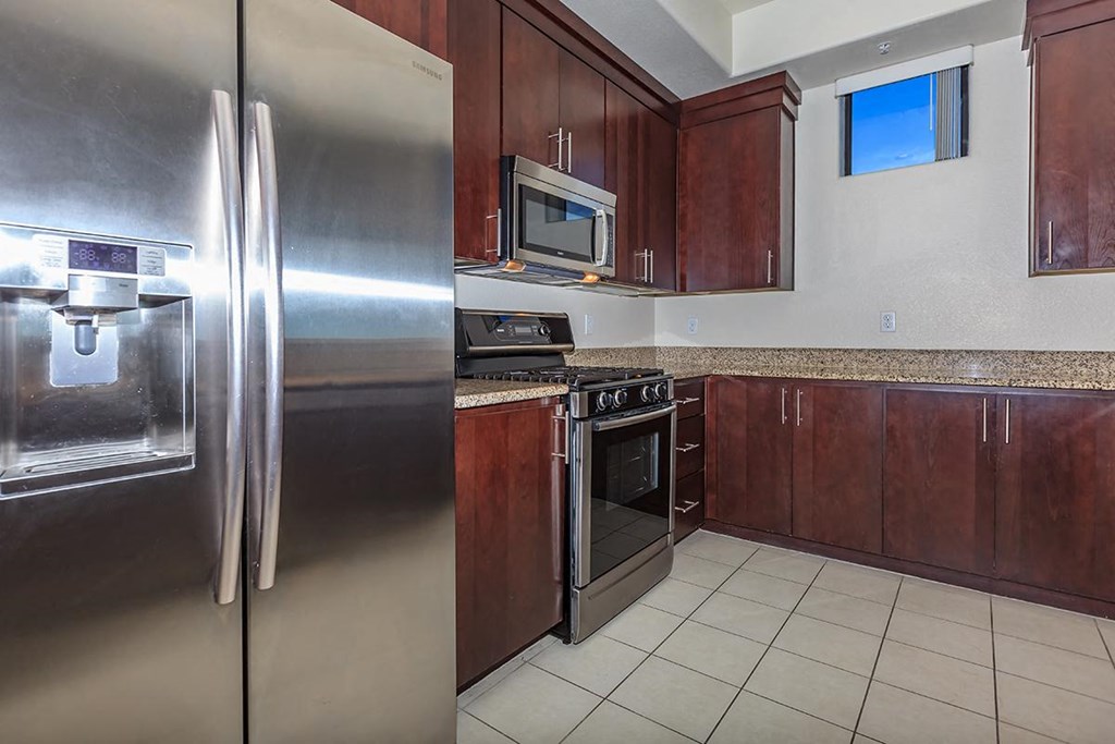 a kitchen with stainless steel appliances and wooden cabinets