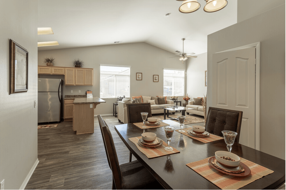 a kitchen and dining room with a table and chairs