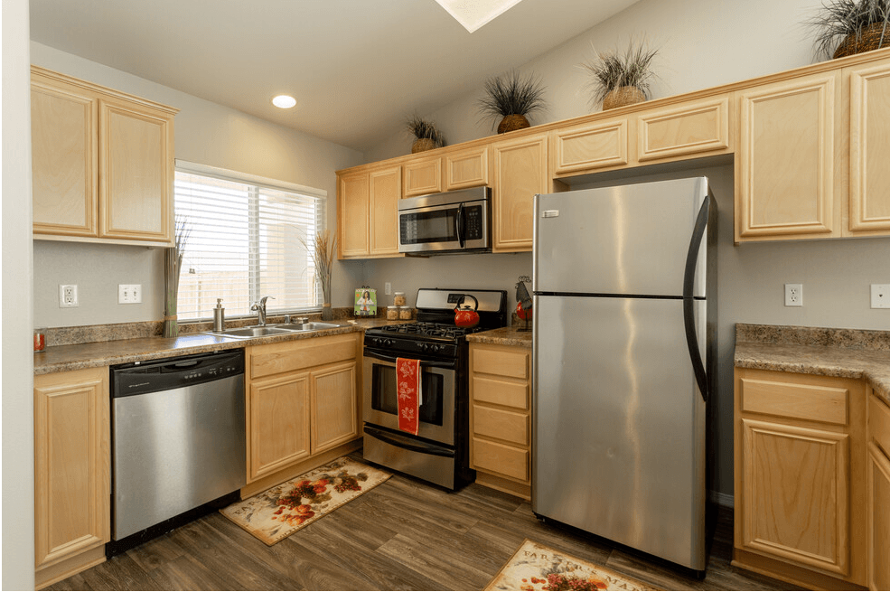 a kitchen with stainless steel appliances and wooden cabinets