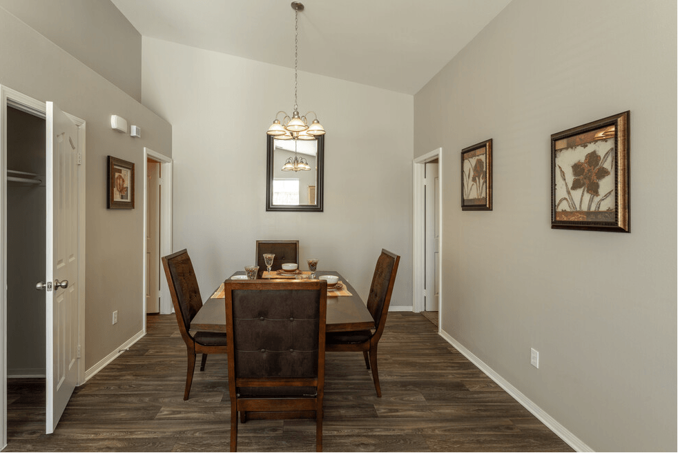 a dining room with a table and chairs