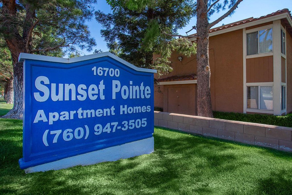 a sunset pointe apartment homes sign in front of a house