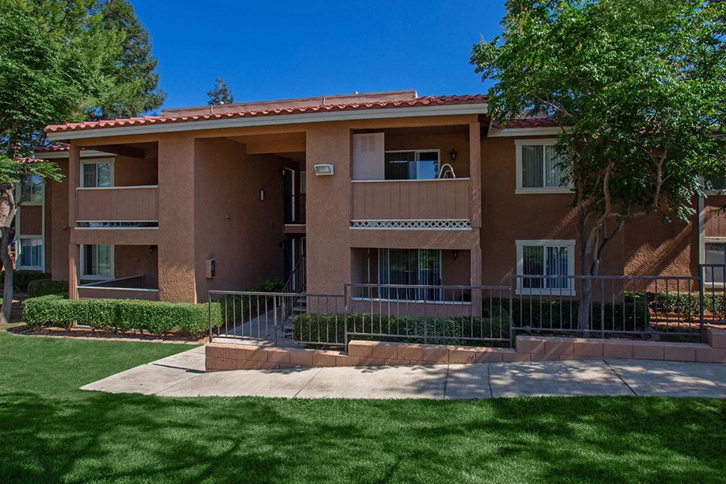 an apartment building with a yard in front of it