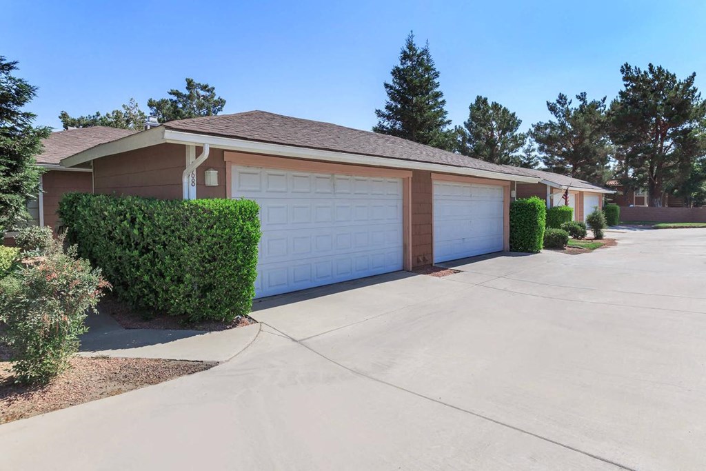 a home with a white garage door and a driveway