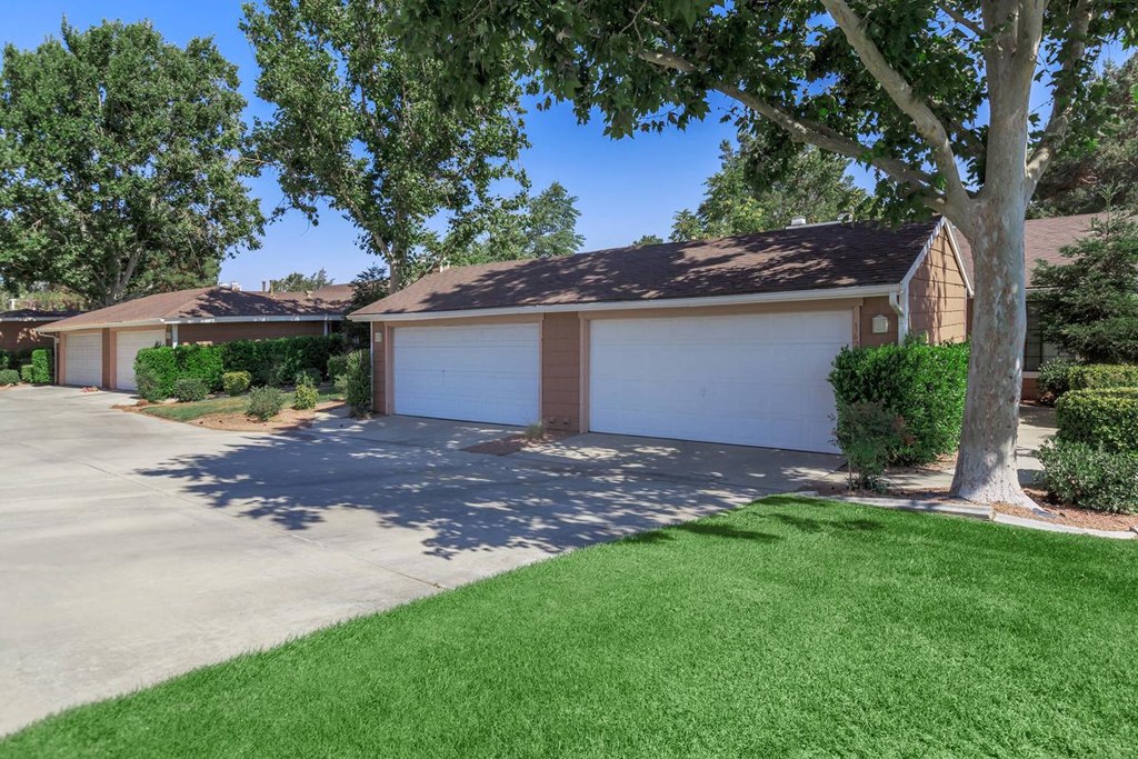 a garage with a white garage door in front of a house