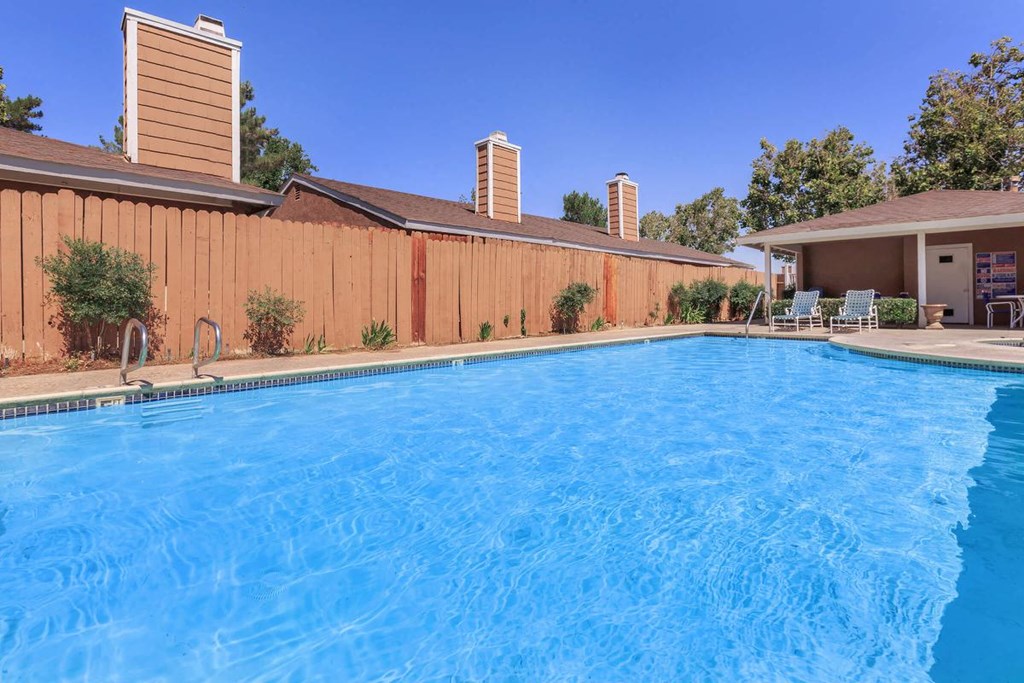 a large swimming pool in front of a house
