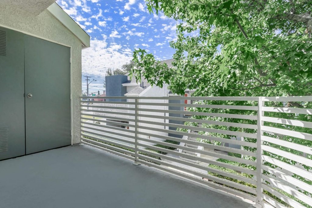 a balcony with a white fence and a garage door