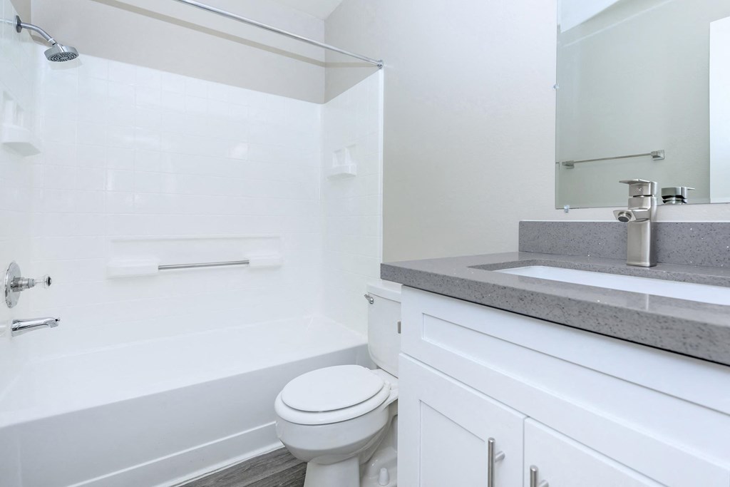 a white bathroom with a sink and a toilet