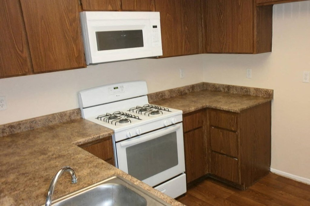 a kitchen with a stove and a sink