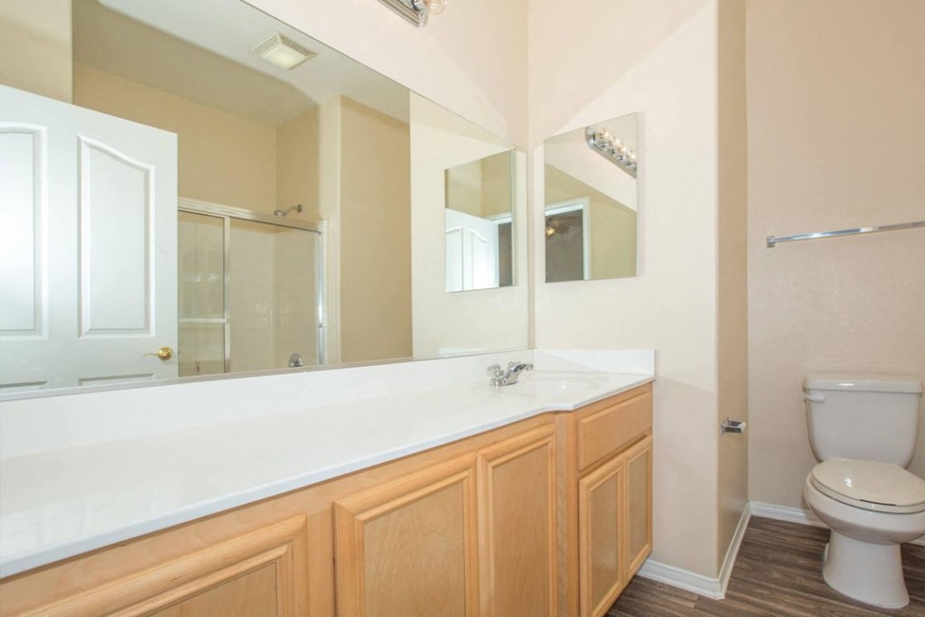 A white toilet sits next to a sink in a bathroom.