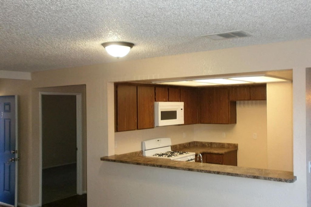 a kitchen with a counter top and a microwave