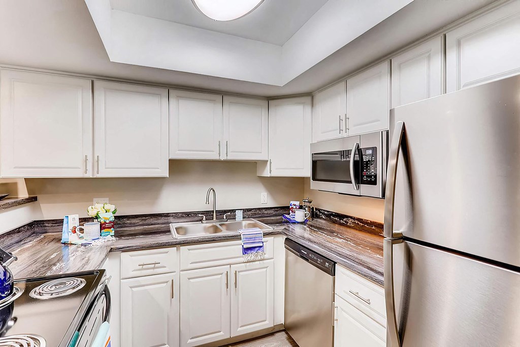 a kitchen with stainless steel appliances and white cabinets