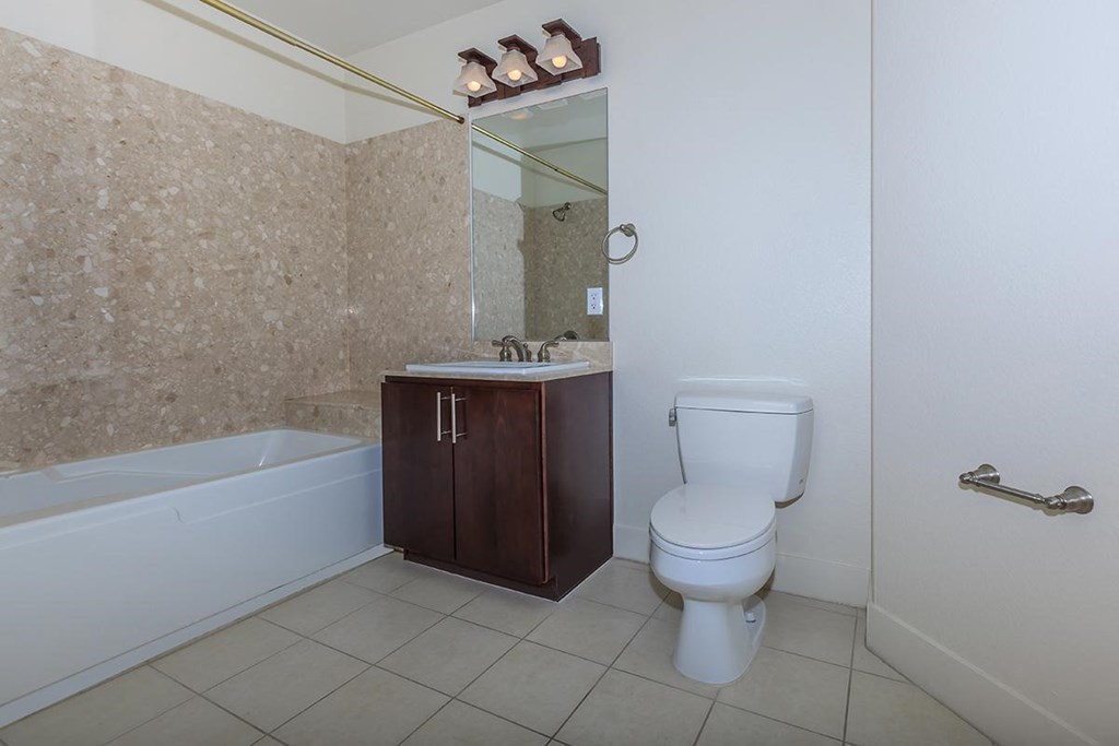 a bathroom with a toilet and a sink and a bath tub