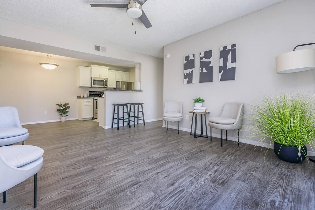 a living room and kitchen with a wood floor