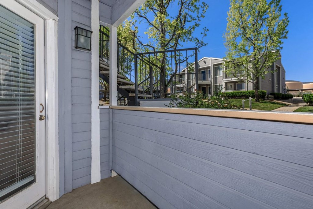 the side of a house with a balcony and a door