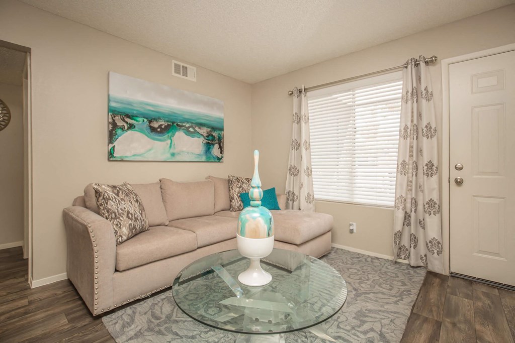 a living room with a couch and a glass table