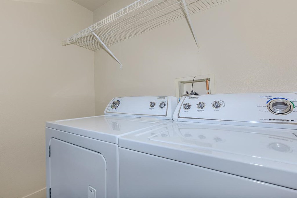 a laundry room with two washes and a dryer