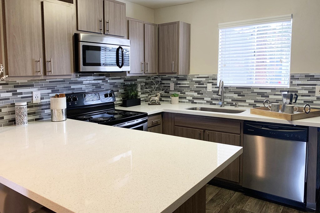 a kitchen with a counter top and a stove and a microwave
