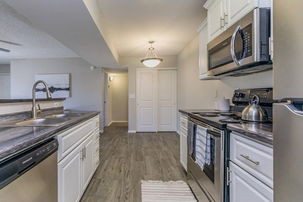 a kitchen with stainless steel appliances and white cabinets