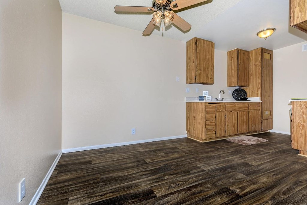 A room with wooden floors and a ceiling fan.