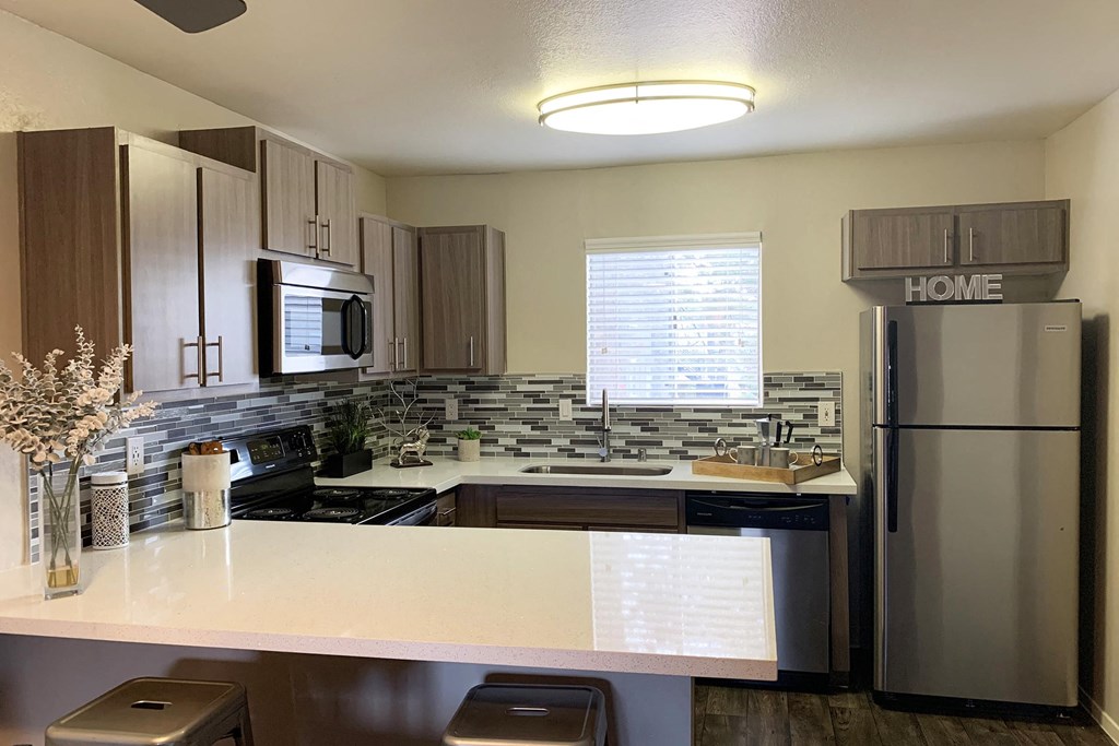 a kitchen with stainless steel appliances and a counter top