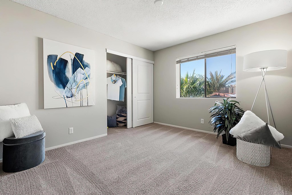 an empty living room with a window and a plant