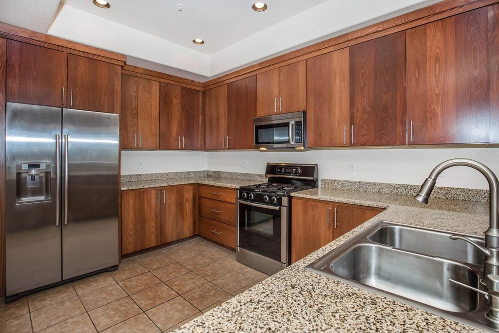 a kitchen with stainless steel appliances and granite counter tops